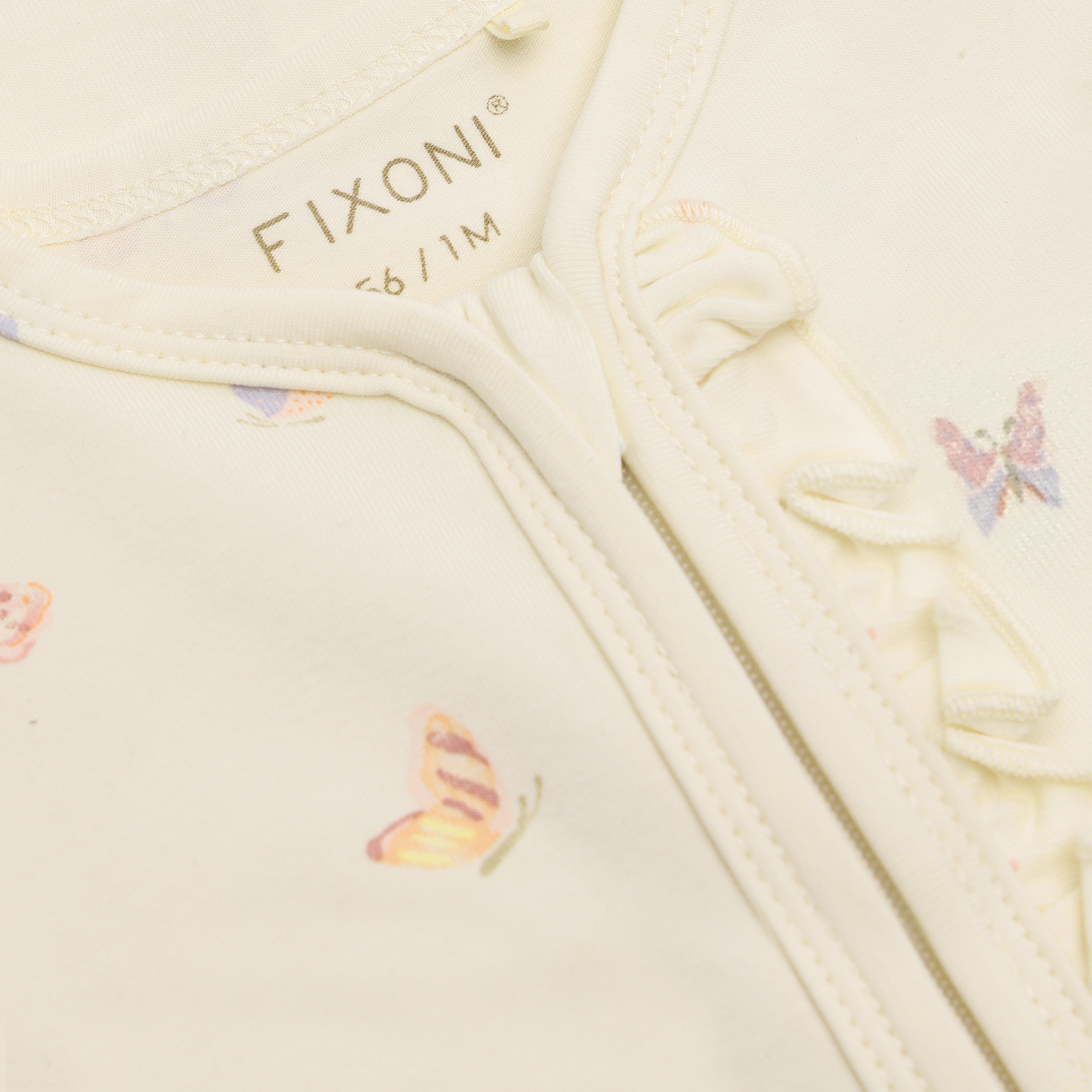 Fixoni lukuga beebide kombinesoon liblikatega